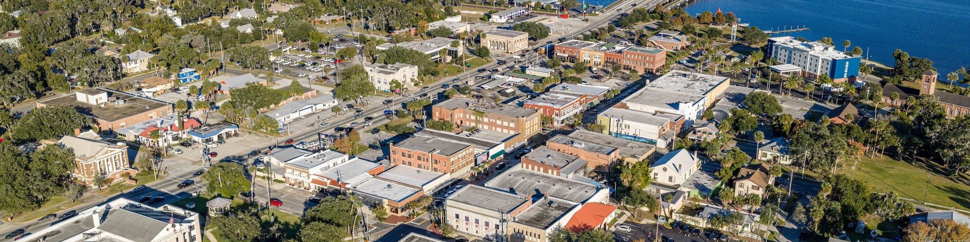 An aerial view of a coastal town with a prominent bridge connecting to the mainland.