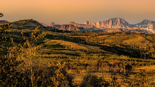 Un paisaje montañoso con un valle y un río.
