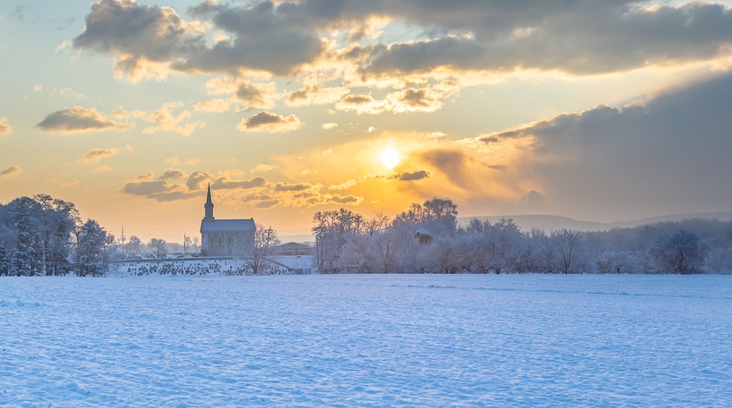 Winter Sunrise Over A Rural Church