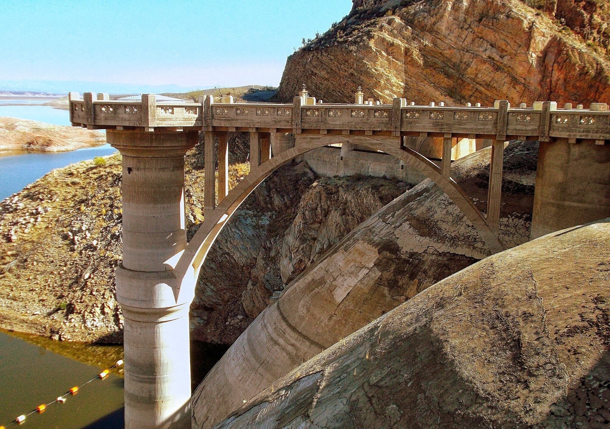 Building began in 1924, the dam opened in 1930.  31 miles SE of Globe Arizona.
 You can still cross the Dam by car or foot.  It's a beautiful sight.... And for rock hounds, it's a wonderful find.