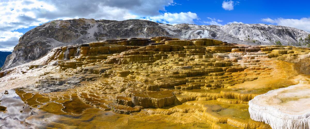 Mammoth Hot Springs, terrace-like cascade of steaming travertine pools in Yellowstone National Park, Park County, Wyoming, USA: The Majestic Panoramic Landscape