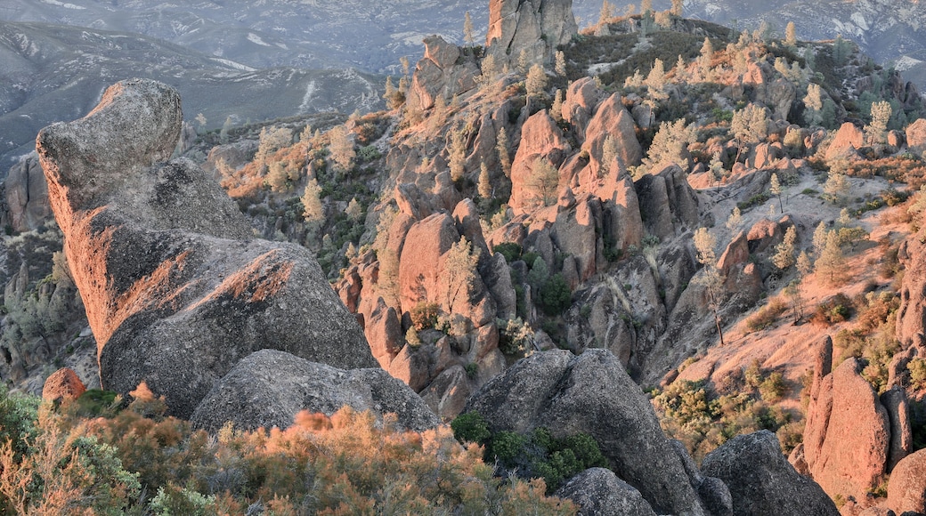 A rugged mountainous landscape with prominent rock formations and sparse vegetation.