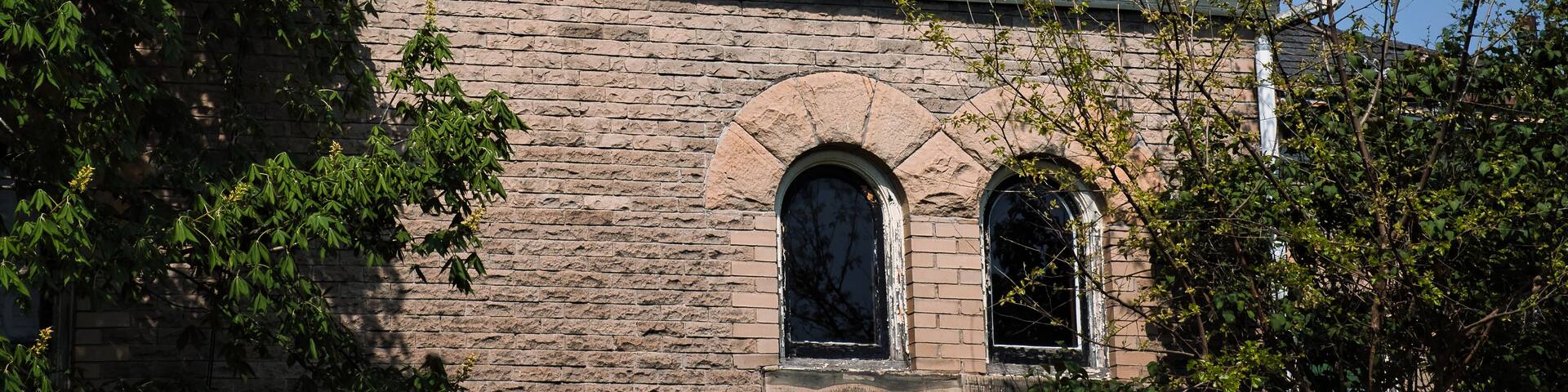 A historic building with a large dome and arched windows.