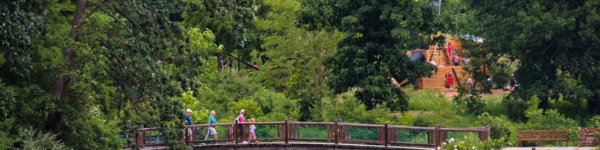 Family Walking Across Scenic Bridge