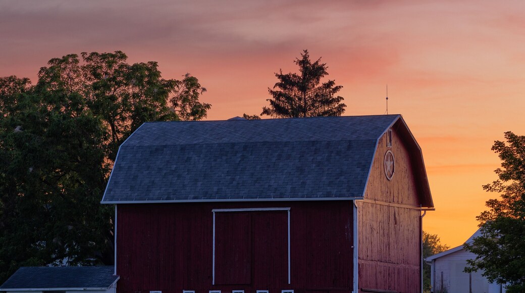 Sunset behind a red barn in rural Michigan