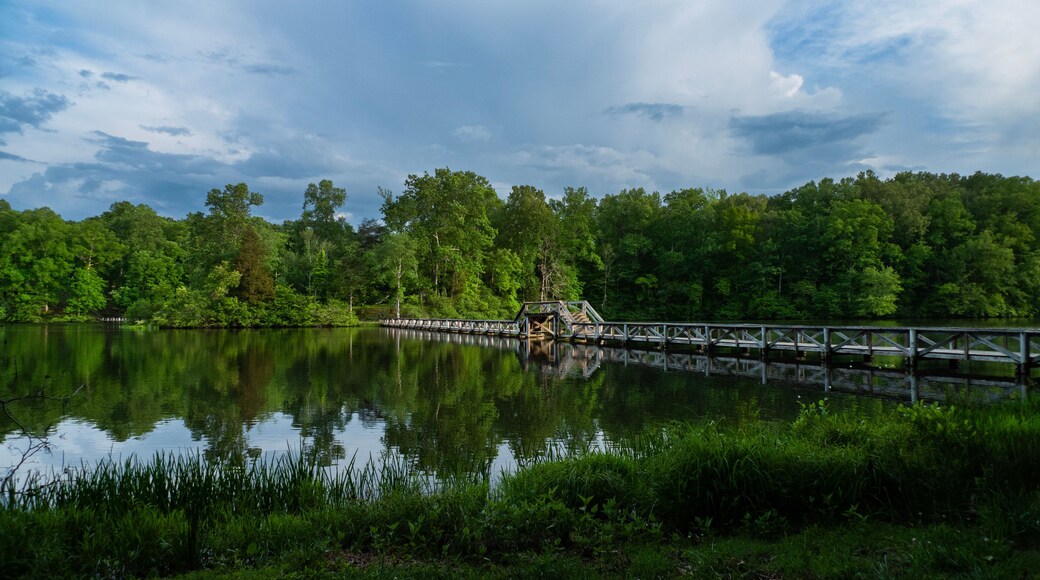 Foot bridge over the lake with reflections, stormy sky