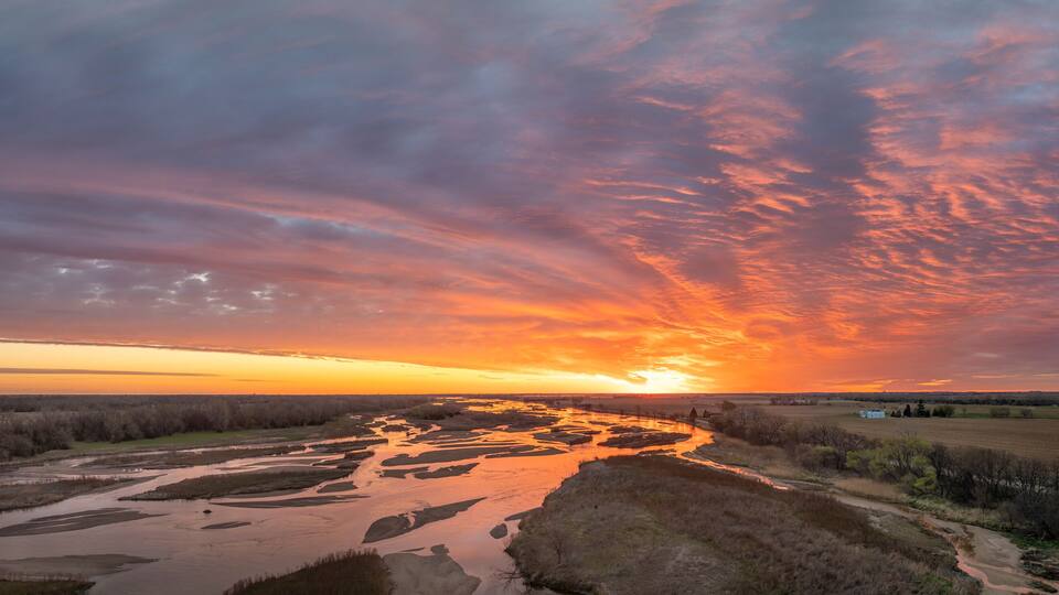 springtime sunrise over Platte River and plains near Kerney, Nebraska, aerial panorama