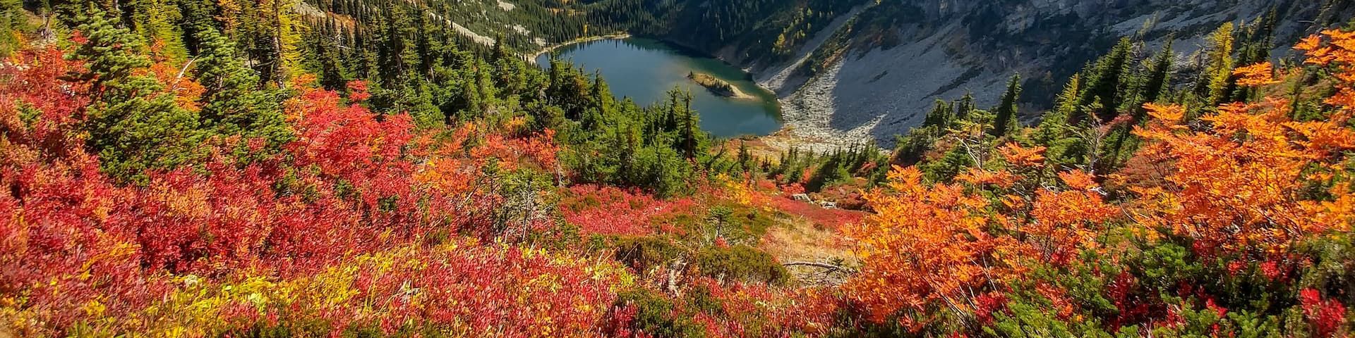 Brilliant reds, oranges, yellows, greens, and blues color the landscape in autumn near the backside of the Maple Pass Loop just outside of North Cascades National Park. Fall is an excellent time to go with near perfect temperatures and gorgeous scenery. This area is about 3 hours from Seattle.