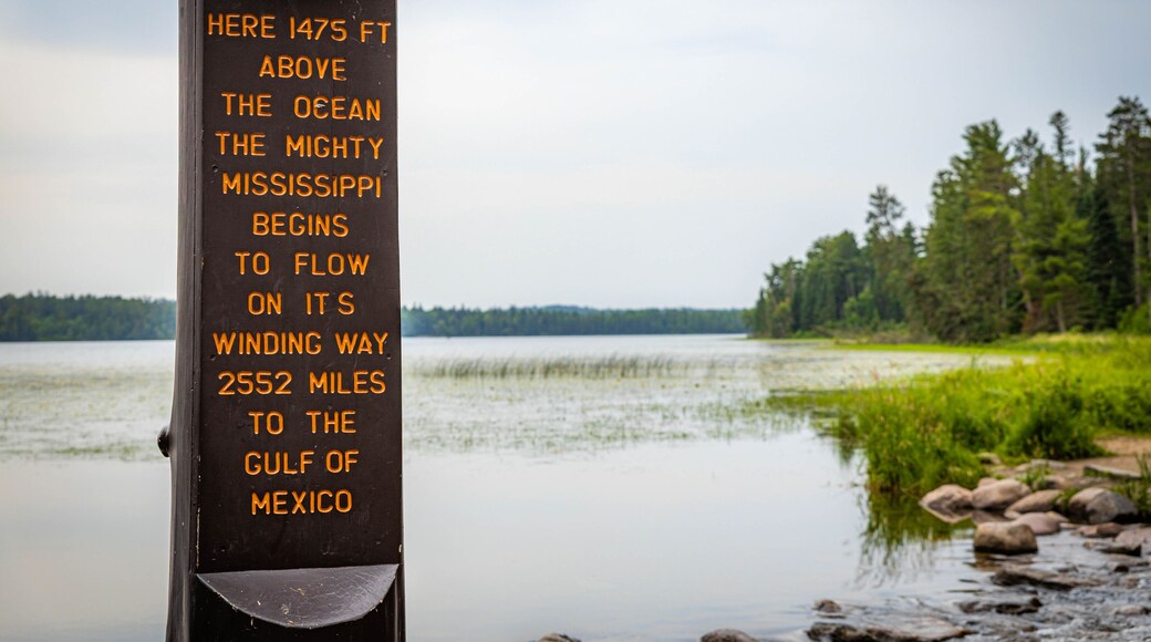 A sign by a lake with text about the Mississippi River's flow.