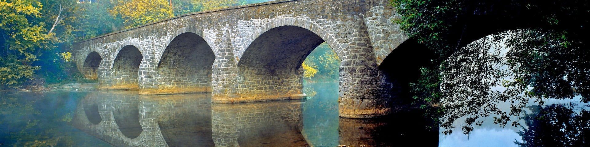 USA, Maryland, Hagerstown. Mist the lovely reflection of the stone curves of Wilson Bridge, at Hagerstown in Maryland.