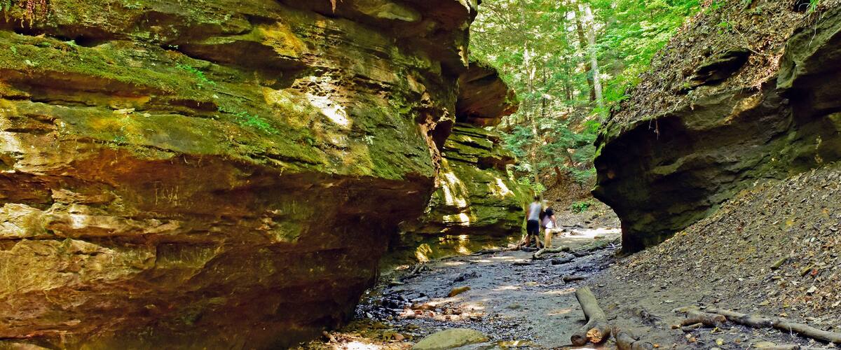 A couple winds their way through a ravine stream in Turkey Run State Park, Indiana.