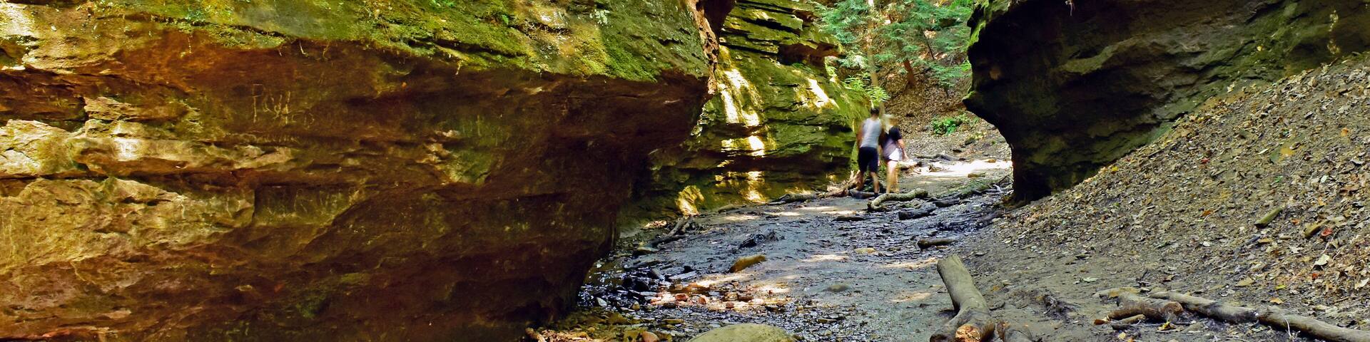 A couple winds their way through a ravine stream in Turkey Run State Park, Indiana.