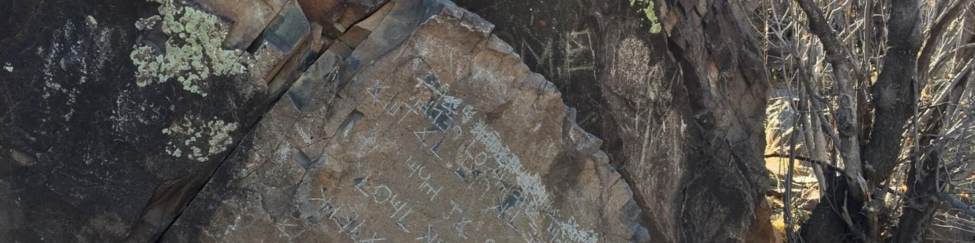 The Decalogue stone is nestled in a canyon on Hidden Mountain, about a mile hike from the nearest road. The inscription has been interpreted as an abbreviated version of the Ten Commandments written in an ancient form of Hebrew, but there is no evidence of its authenticity.