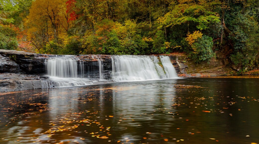 A red stone pebble heart on the dry desert ground with inspirational text.