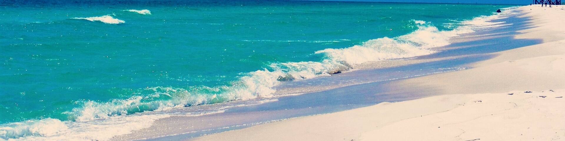 This beach and it's pristine water are accessible only by boat. This side on the Gulf Of Mexico is an Aquatic Preserve. The bay side is on St Andrews Bay. It is a favorite place for local boaters to gather.