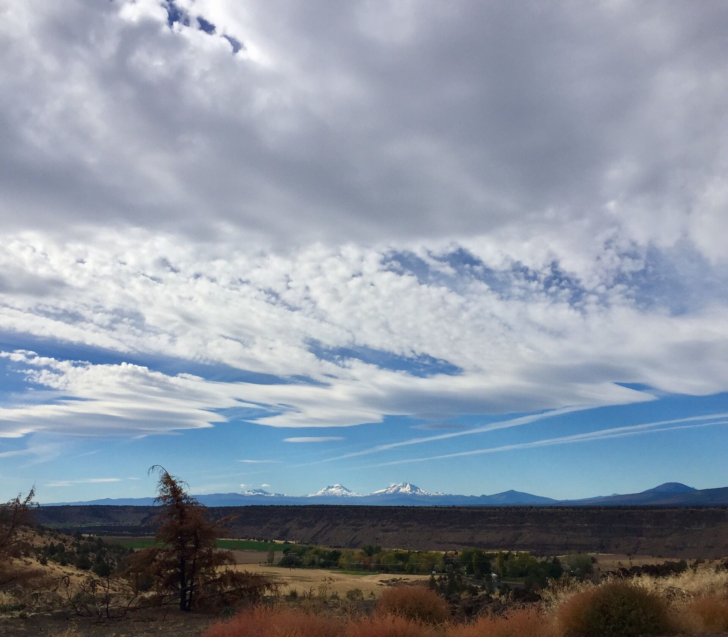 Three sisters in the distance. I love the contrast of colours between the sky and ground. 