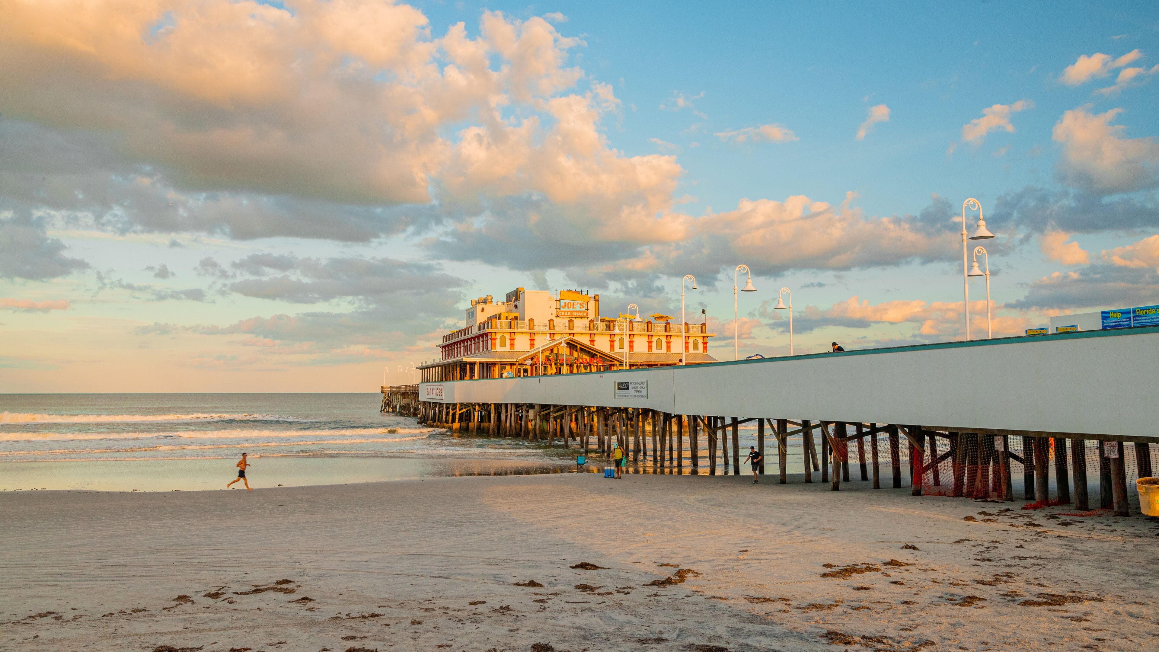 A beach with a pier and a building named "Joe's Crab Shack".