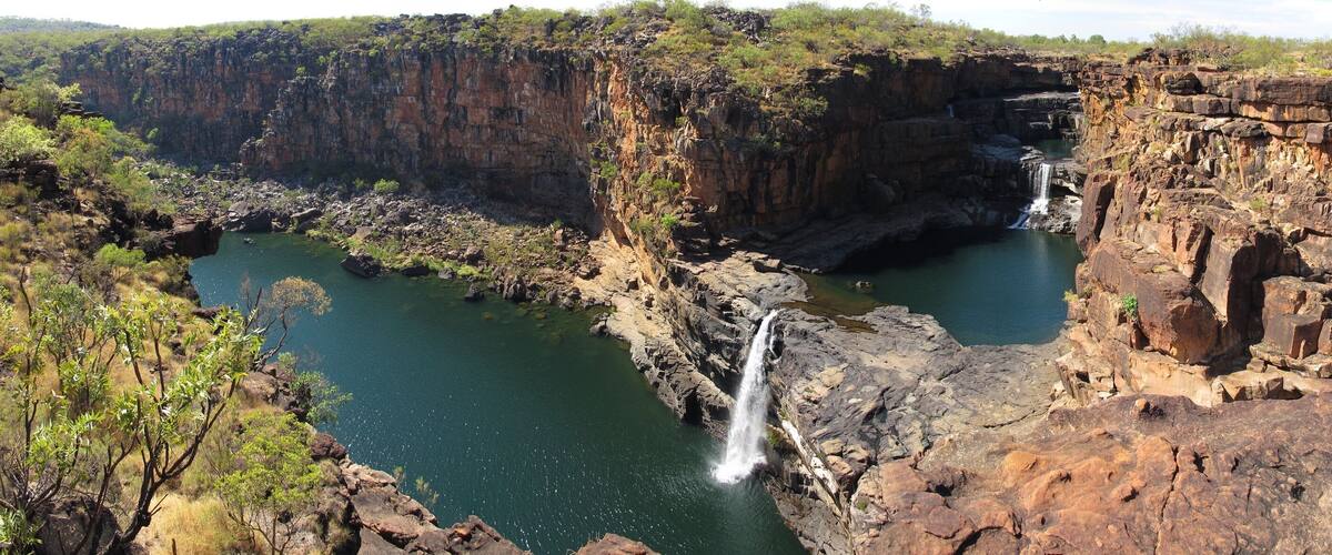A canyon with two waterfalls and a river.
