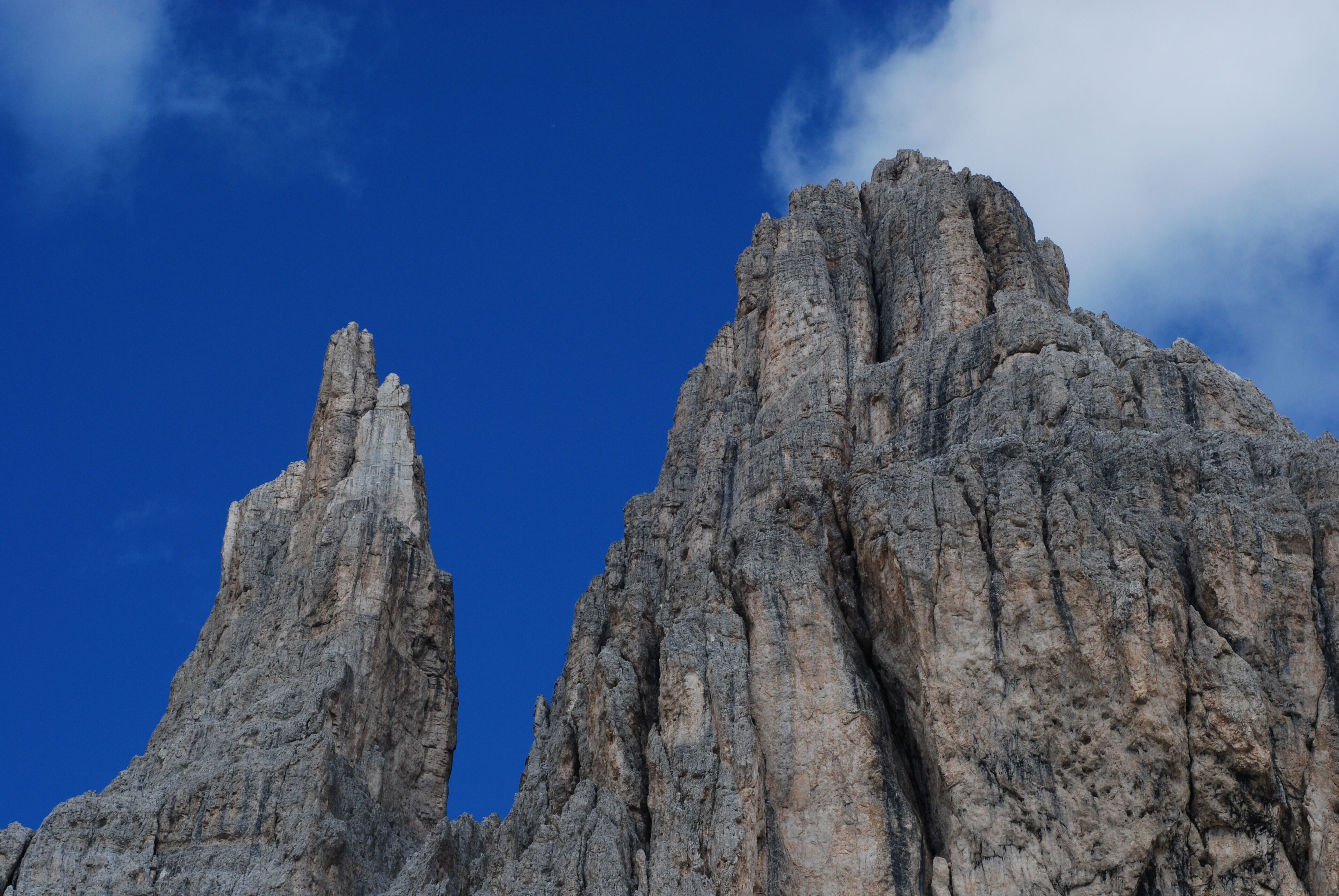 A rugged mountain peak with a clear blue sky.