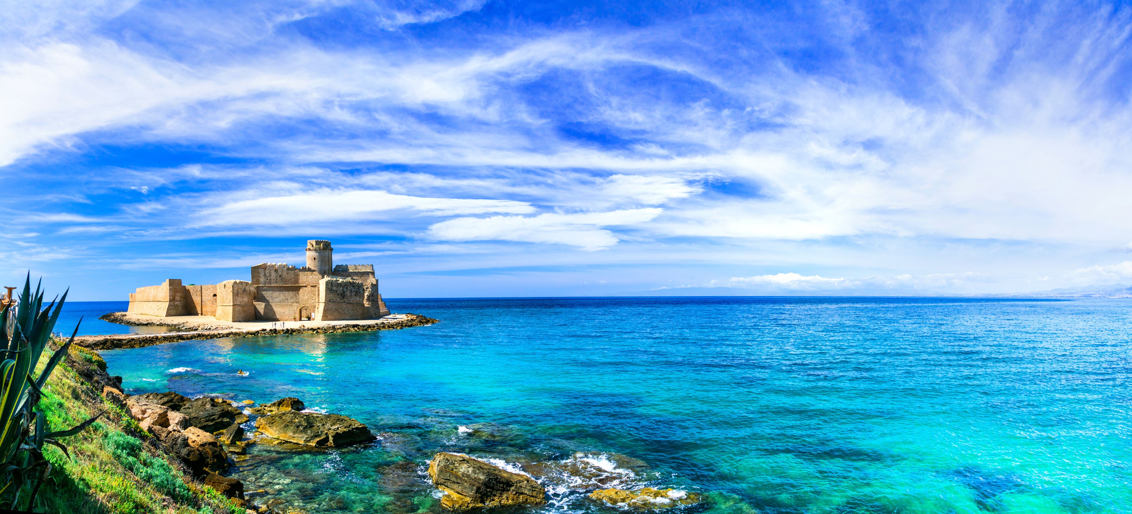 Italy Calabria Le Castella Aragonese castle in European Caribbean turquoise sea. Panorama of rocky coast and Mediterranean aesthetics Isola di Capo Rizzuto