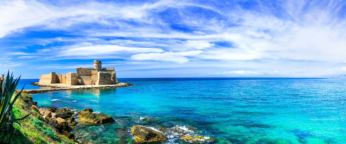 Italy Calabria Le Castella Aragonese castle in European Caribbean turquoise sea. Panorama of rocky coast and Mediterranean aesthetics Isola di Capo Rizzuto