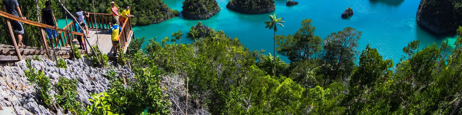 Pianemo ;a cluster of small coral islands surrounded by clear water and its hills covered by green vegetation ; Raja Ampat , Indonesia