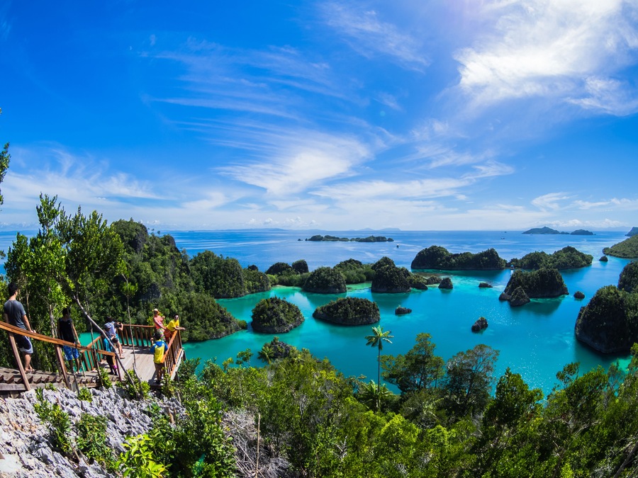 Pianemo ;a cluster of small coral islands surrounded by clear water and its hills covered by green vegetation ; Raja Ampat , Indonesia