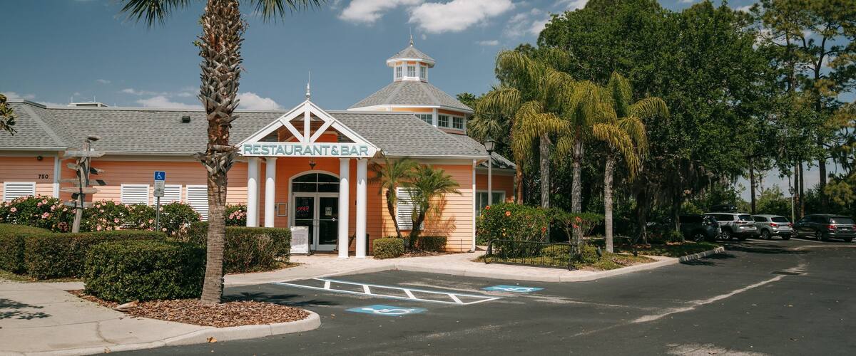 A restaurant and bar with a distinctive tower and palm trees.