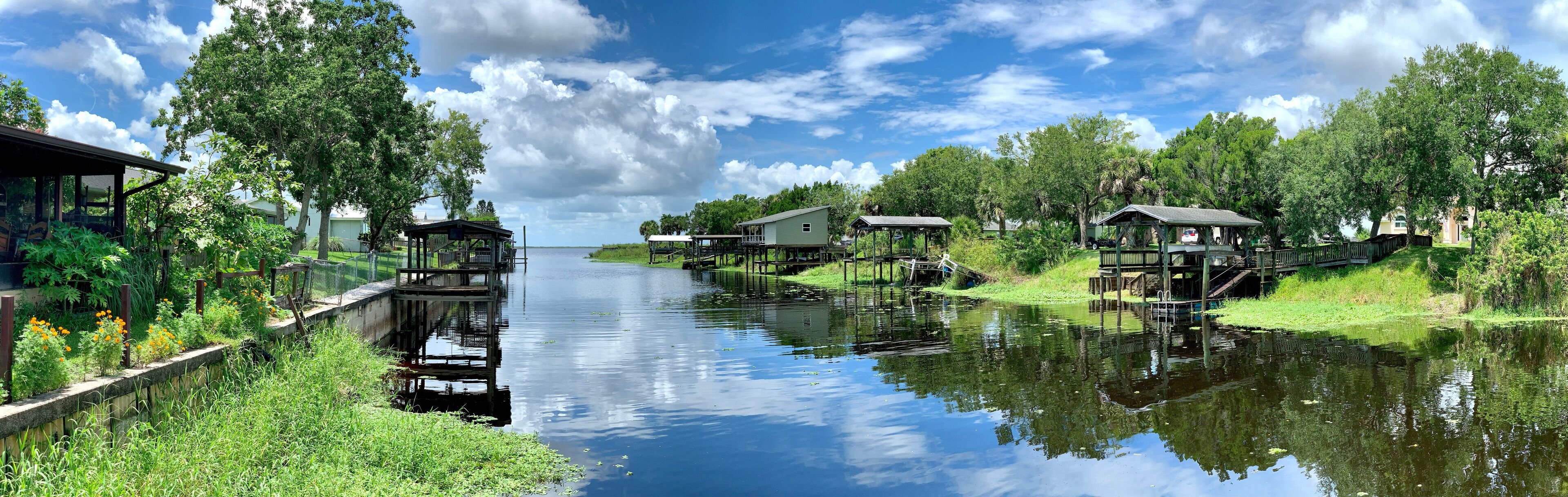 Boat docks lining a canal leading to a freshwater lake in central Florida