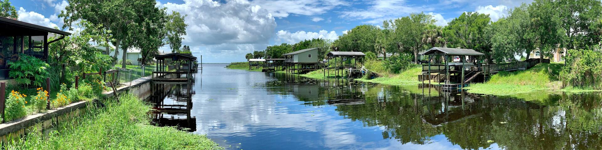 Boat docks lining a canal leading to a freshwater lake in central Florida