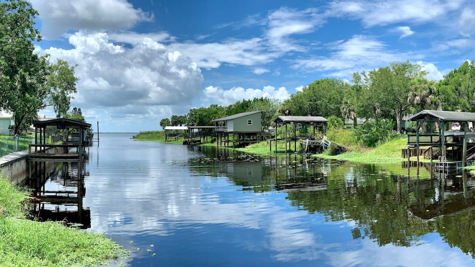 Boat docks lining a canal leading to a freshwater lake in central Florida