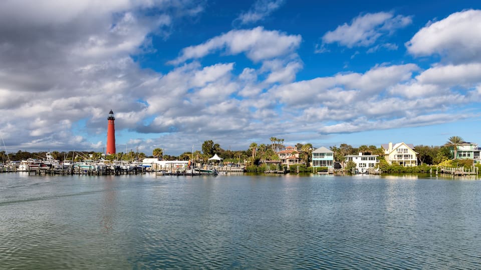 Ponce Inlet Lighthouse in harbor at sunny day, Daytona Beach, Florida, USA.