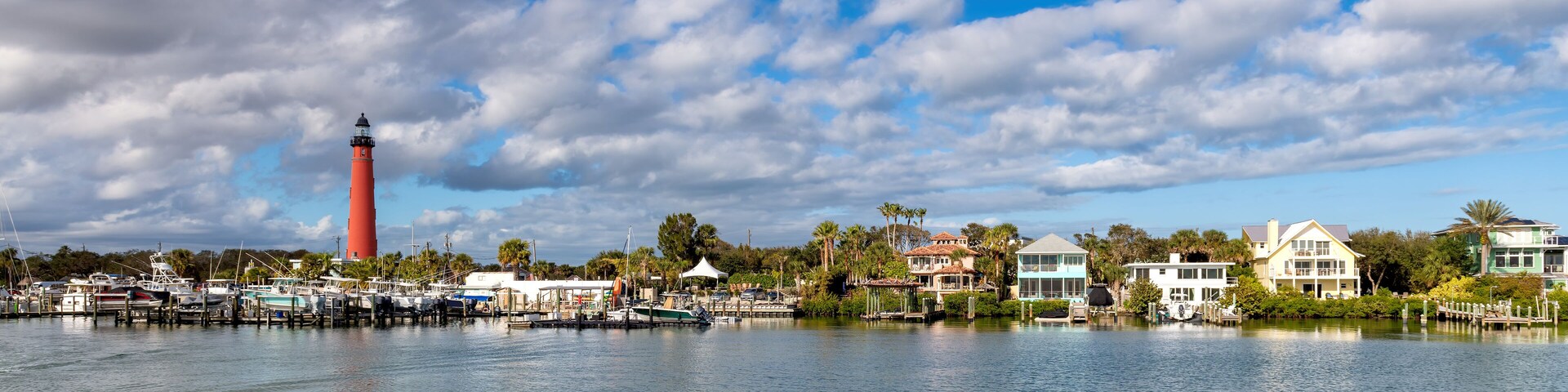 Ponce Inlet Lighthouse in harbor at sunny day, Daytona Beach, Florida, USA.