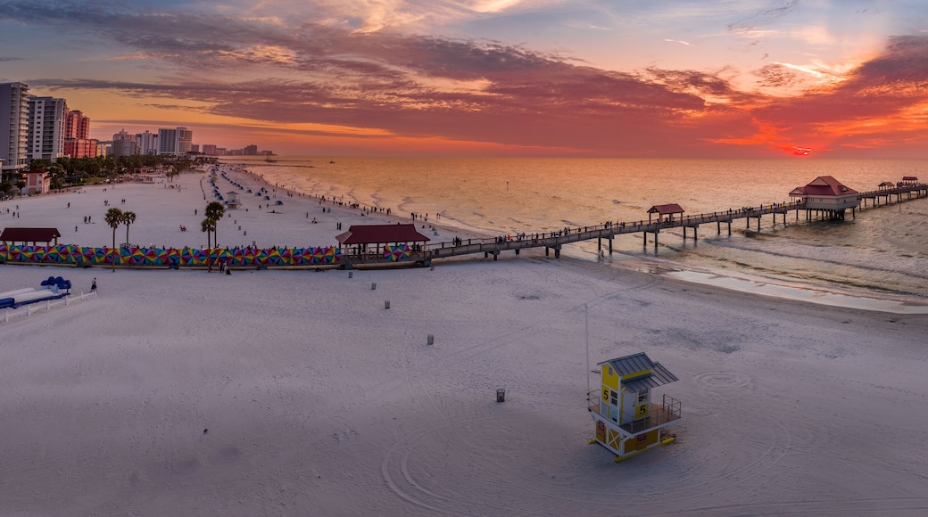 Sunset at Clearwater beach with Pier 60 fishing pier, white sand beach dramatic colorful sky