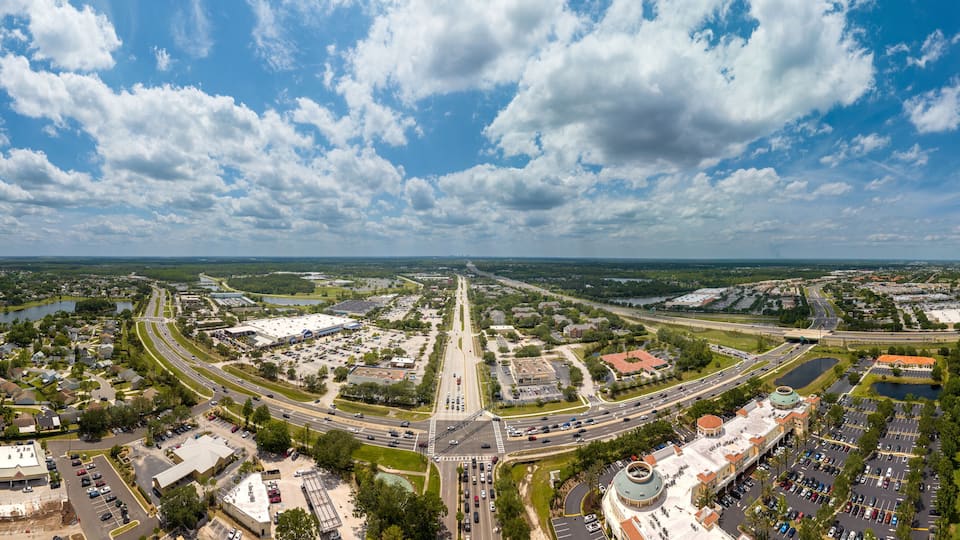 Aerial wide panoramic view of east Orlando (Waterford Lakes), Florida. USA with downtown Orlando city in the distant skyline. May 5, 2023.