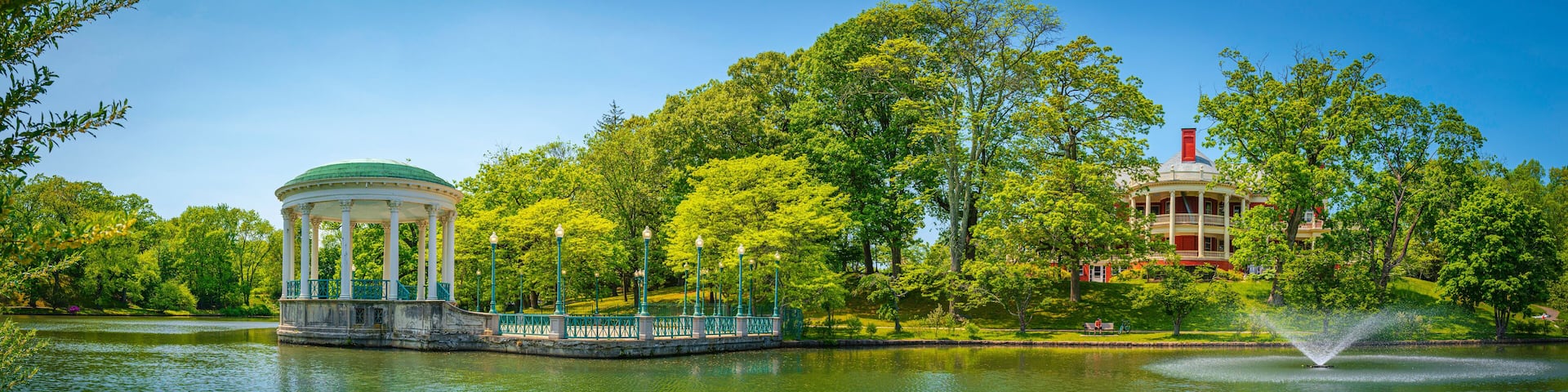 Bandstand Pavilion and water fountain on the Roosevelt Lake and forest at Roger Williams Park, Providence, Rhode Island
