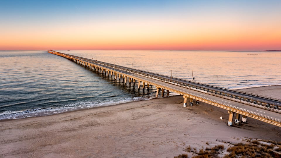 Aerial panorama of Chesapeake Bay Bridge Tunnel at sunset. CBBT is a 17.6-mile bridge tunnel that crosses the mouth of the Chesapeake Bay.