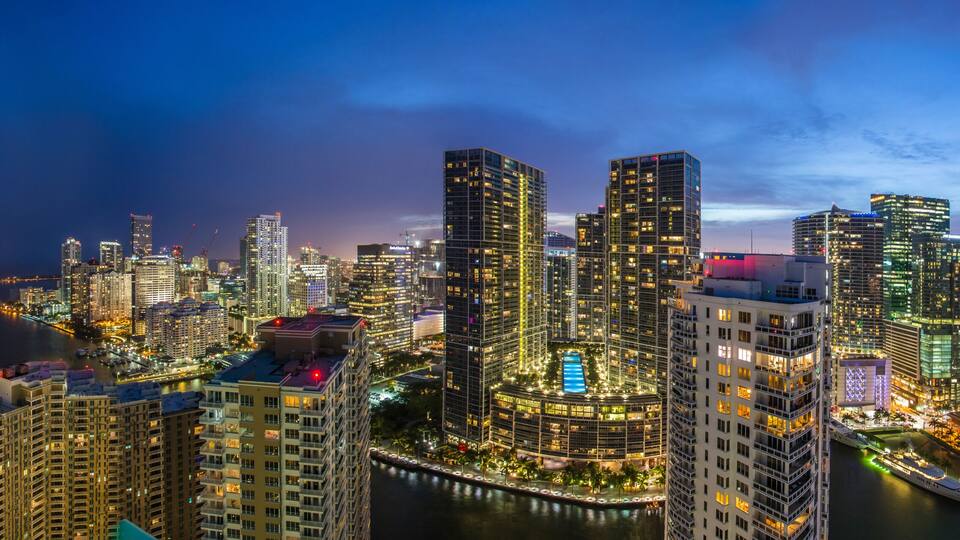 Aerial view of futuristic and luxurious city skyline at night, Miami, Florida, United States.