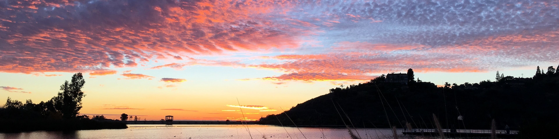Beautiful sunset over a quiet Lake Murray in San Diego California