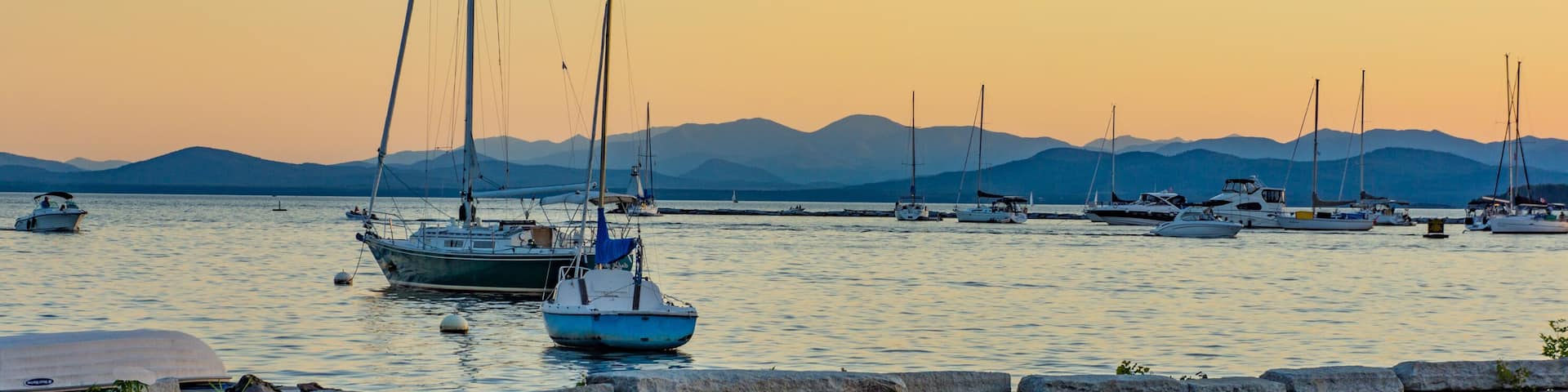 sails boats moored in lake at dusk in the evening