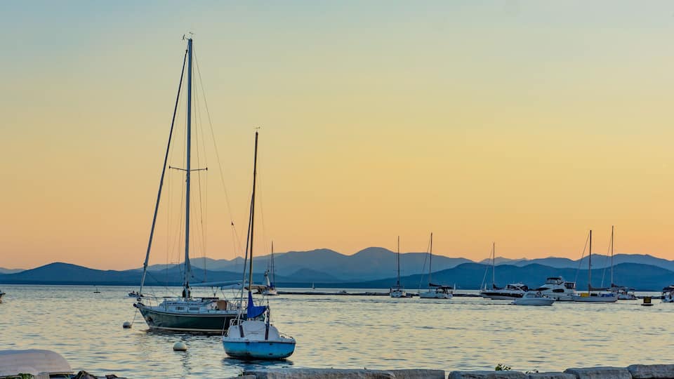 sails boats moored in lake at dusk in the evening
