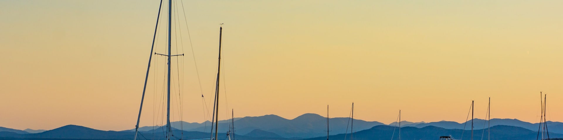 sails boats moored in lake at dusk in the evening