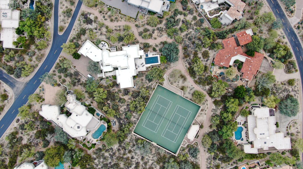 Aerial top view of upscale luxury homes with pool and tennis court in Scottsdale, Phoenix, Arizona