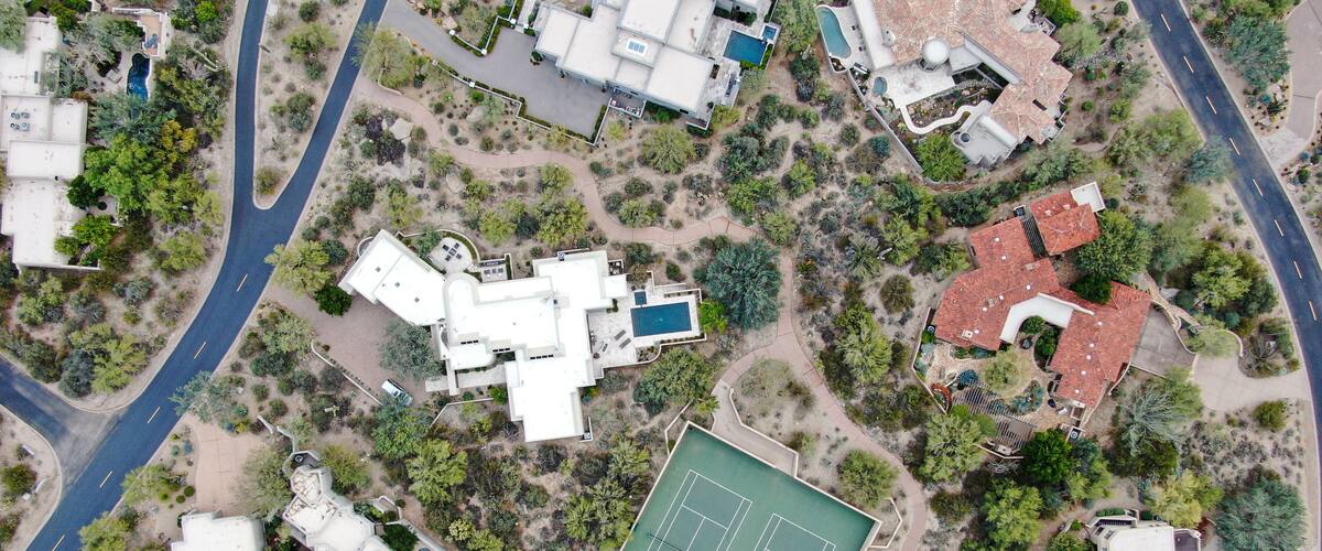 Aerial top view of upscale luxury homes with pool and tennis court in Scottsdale, Phoenix, Arizona