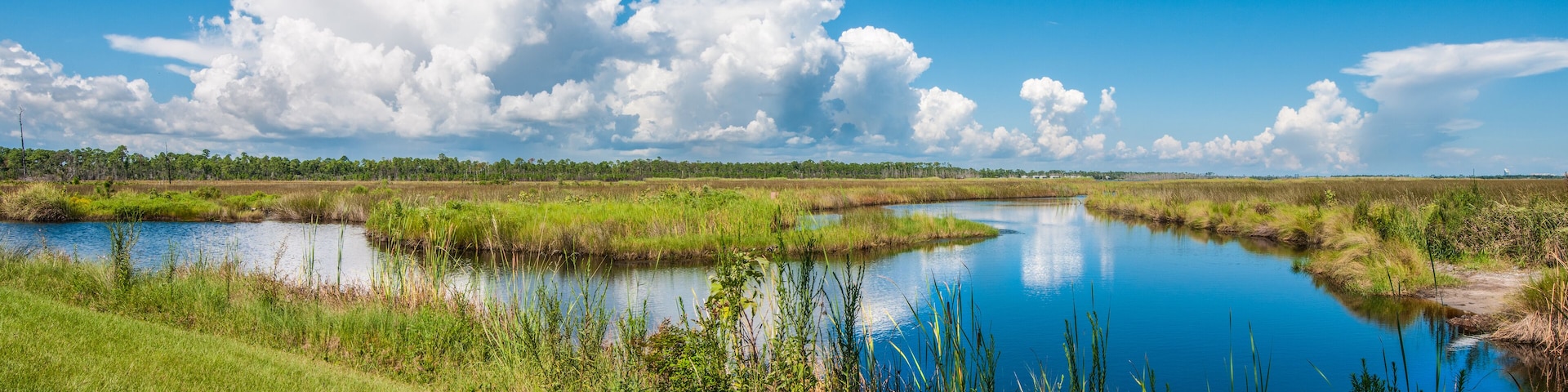 Panorama of canals in Gulf Shores State Park in Alabama USA with reflections of sky on water