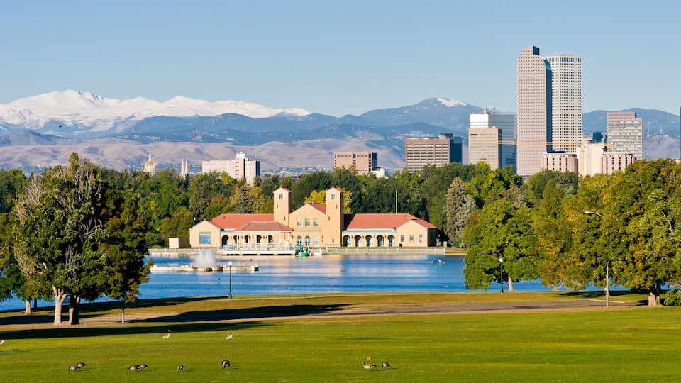 City Park Denver Panorama on a summer day with snow capped Mount Evans in the background and geese in the foreground