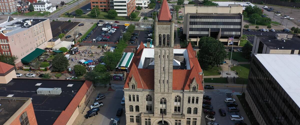 Vibrant aerial perspective of Parkersburg, West Virginia, highlighting historic buildings, the bustling downtown area, and the natural beauty along the Ohio River.