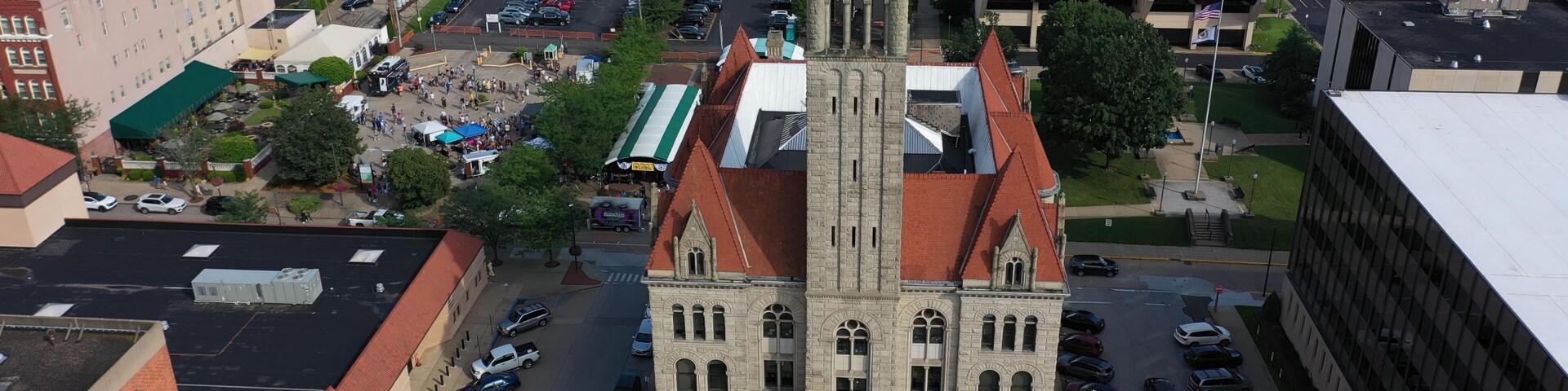 Vibrant aerial perspective of Parkersburg, West Virginia, highlighting historic buildings, the bustling downtown area, and the natural beauty along the Ohio River.