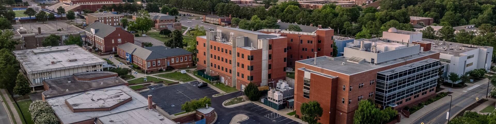 Aerial view of Fayetteville state university historically black college administration building with dramatic colorful sunset sky