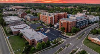 Aerial view of Fayetteville state university historically black college administration building with dramatic colorful sunset sky